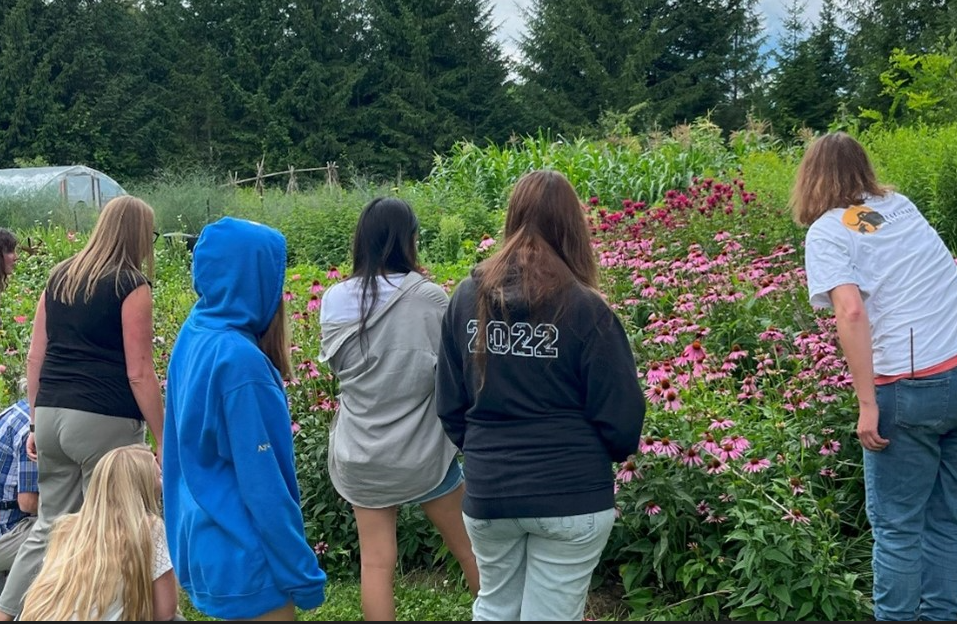 Beekeeper and Lead Agricultural Instructor Janine McGowan encourages program participants to stop and observe bee activity surrounding wildflowers.